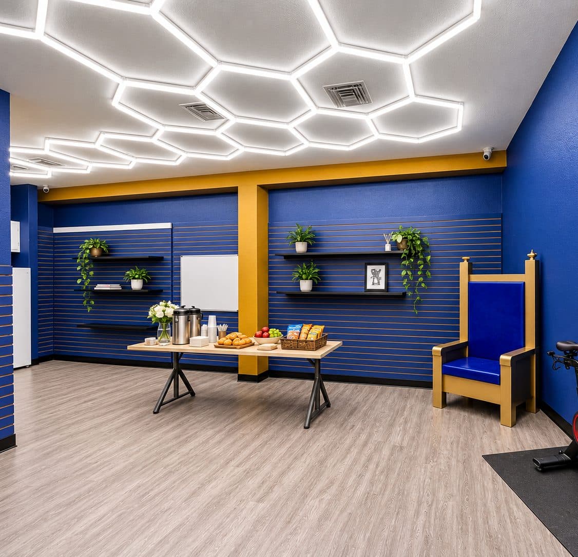Blue and gold room with hexagon ceiling lights, a refreshment table, display shelves, and a gold throne chair